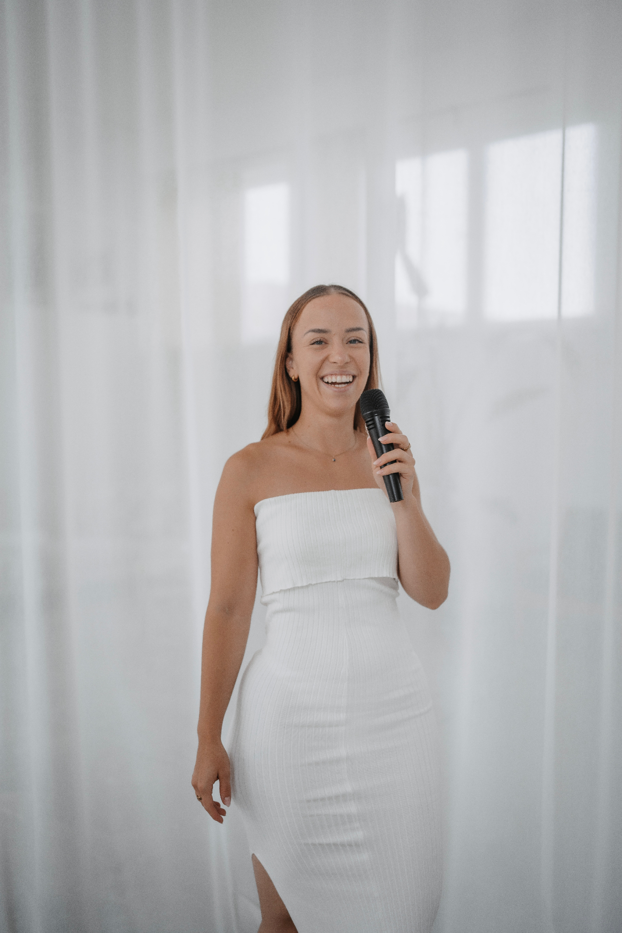 Franziska Bloching speaking, holding a microphone